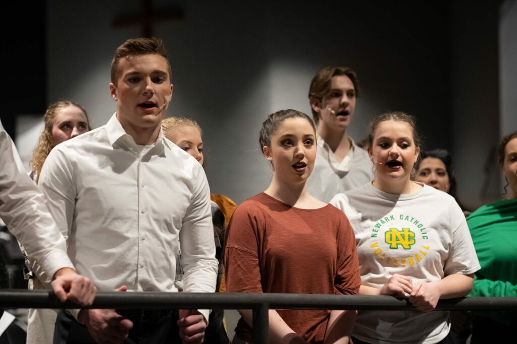 Group of people with stage makeup singing.