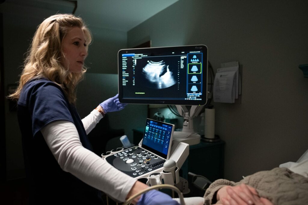 A nurse giving an ultrasound to a patient.